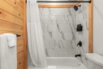  Ensuite Bathroom to Primary Bedroom offers custom tile tub shower